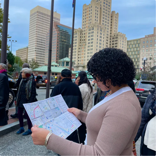 woman looking at map of art galleries of providence